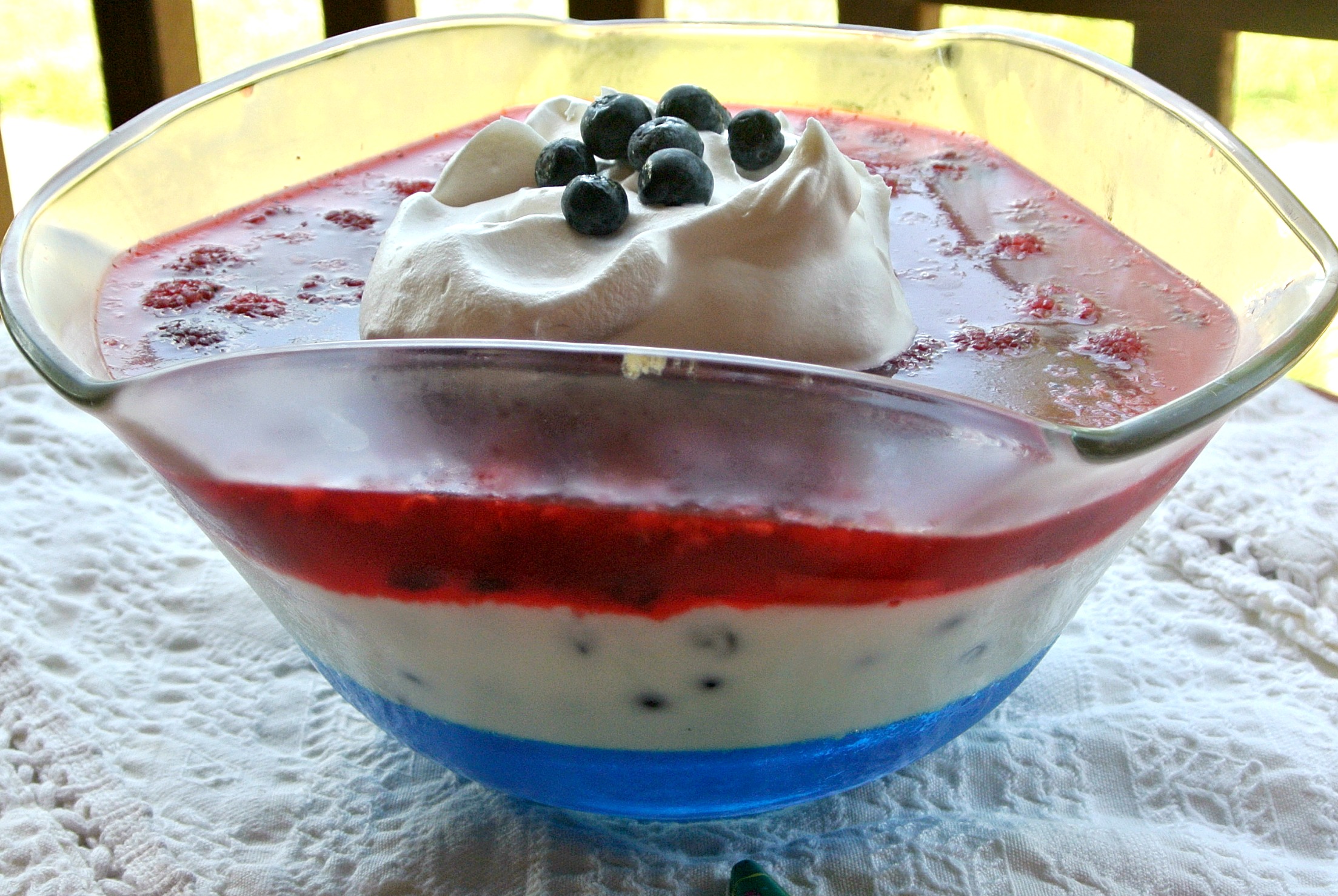 This salad is perfect for the 4th of July and includes raspberry and blueberry jellos, blueberries, raspberries, vanilla yogurt, gelatin, heavy whipping cream, sugar, and whipped topping.