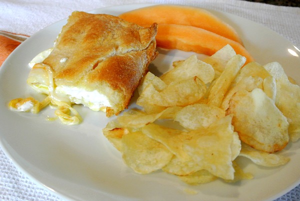 Crescent rolls, cream cheese, three types of cheese, butter, and an egg is what is in this delicious dish.