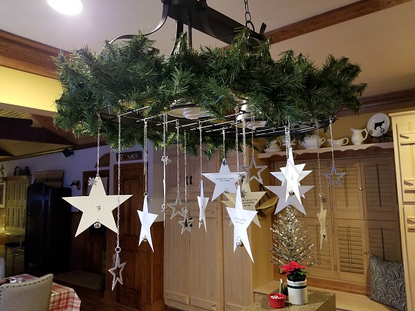Star ornaments hanging from a light.