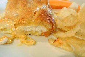 Crescent rolls, cream cheese, three types of cheese, butter, and an egg is what is in this delicious dish.