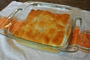 Crescent rolls, cream cheese, three types of cheese, butter, and an egg is what is in this delicious dish.